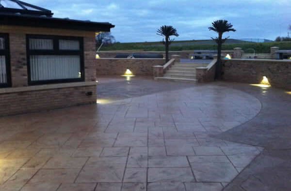 Large modern house drive idea using stamped concrete